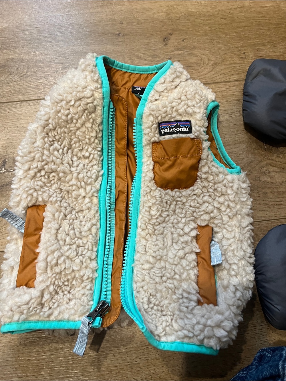 Patagonia Cream Sherpa Vest with Teal Trim and Rust Accents